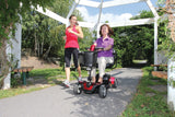 A rider using the Pride Go Go Sport 4-Wheel mobility scooter outdoors