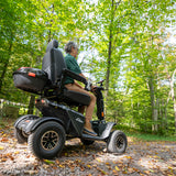 Pride Baja Wrangler 2 off-road mobility scooter on rugged terrain, lifestyle scene