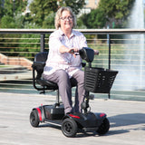 A rider on the Journey Adventure Scooter on a waterfront path
