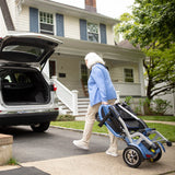 The folded So Lite being wheeled to the back of a car