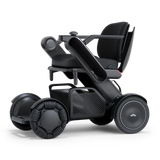 WHILL Model C2 power wheelchair with a black arm cover, three-quarter view