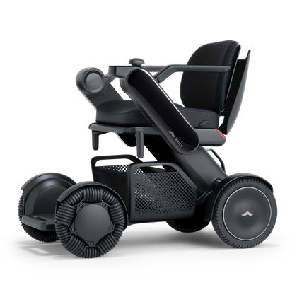 WHILL Model C2 power wheelchair with a black arm cover, three-quarter view