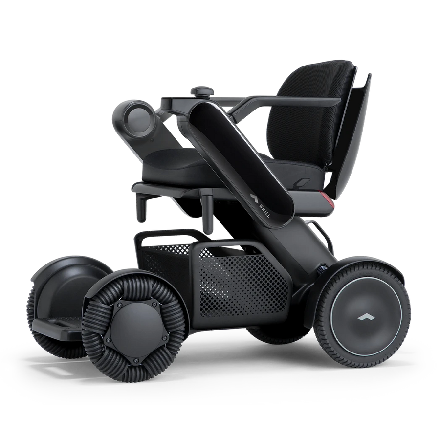 WHILL Model C2 power wheelchair with a black arm cover, three-quarter view