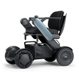 WHILL Model C2 power wheelchair with a blue arm cover, three-quarter view