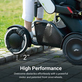The WHILL Model C2 High Back crossing outdoor ground