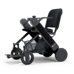 WHILL Model F folding power wheelchair with a black arm cover, three-quarter view