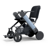 WHILL Model F folding power wheelchair with a blue arm cover, three-quarter view