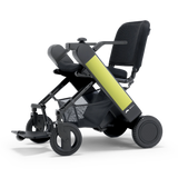 WHILL Model F folding power wheelchair with a green arm cover, three-quarter view