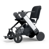 WHILL Model F folding power wheelchair with a white arm cover, three-quarter view