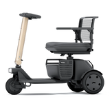 WHILL Model R 3-Wheel mobility scooter with a bronze tiller cover, side view