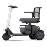 WHILL Model R 3-Wheel mobility scooter with a white tiller cover, side view