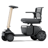 WHILL Model R 4-Wheel mobility scooter with a bronze tiller cover, side view