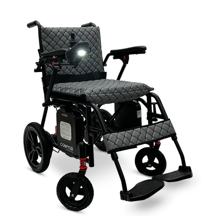 ComfyGo X-7 folding power wheelchair, front three-quarter view with the headlight on