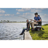 A man fishing from a dock seated in a Merits Vision CF power wheelchair