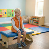 A boy on an Axis bench in a therapy room