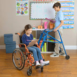 A boy standing in a blue Klip beside a classmate in a wheelchair
