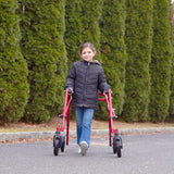 A girl walking outdoors with a red Klip on 8" front wheels