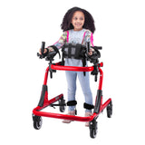 A girl walking in a red Pivot with the trunk support, forearm platforms and ankle prompts fitted
