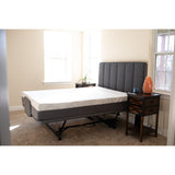 A Flexabed Hi-Low SL adjustable bed with a mattress, shown flat in a bedroom beside a nightstand