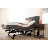 A woman lying on a Flexabed Hi-Low SL with the bed raised and the head and foot sections lifted