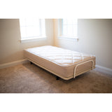 A twin Flexabed Value-Flex adjustable bed with its innerspring mattress, shown flat in a bedroom