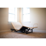 The Flexabed Value-Flex base without a mattress, with the head and the foot sections raised, showing the steel frame and the mattress retainer bar at the foot