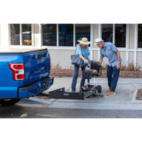 Harmar AL001 Universal Manual Carrier in use, a scooter being taken up the ramp