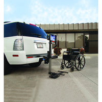 Harmar AL030 Power Tote fitted to the rear of a vehicle with a manual folding wheelchair beside it