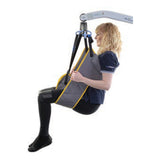 A person lifted in a Hoyer Access Sling