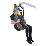 A person lifted in a Hoyer Access Sling with Head Support