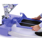 Hands lifting the removable foot tray off the Hoyer Journey base
