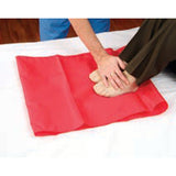 A caregiver placing a Hoyer Slide Sheet on a bed