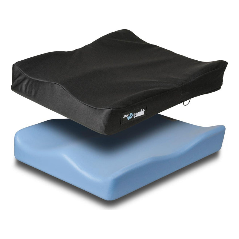 A contoured foam wheelchair cushion with its black cover lifted
