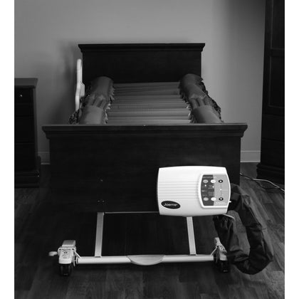 A Joerns DermaFloat APL mattress on a bed with its control unit on the foot panel, from the cover of the manual