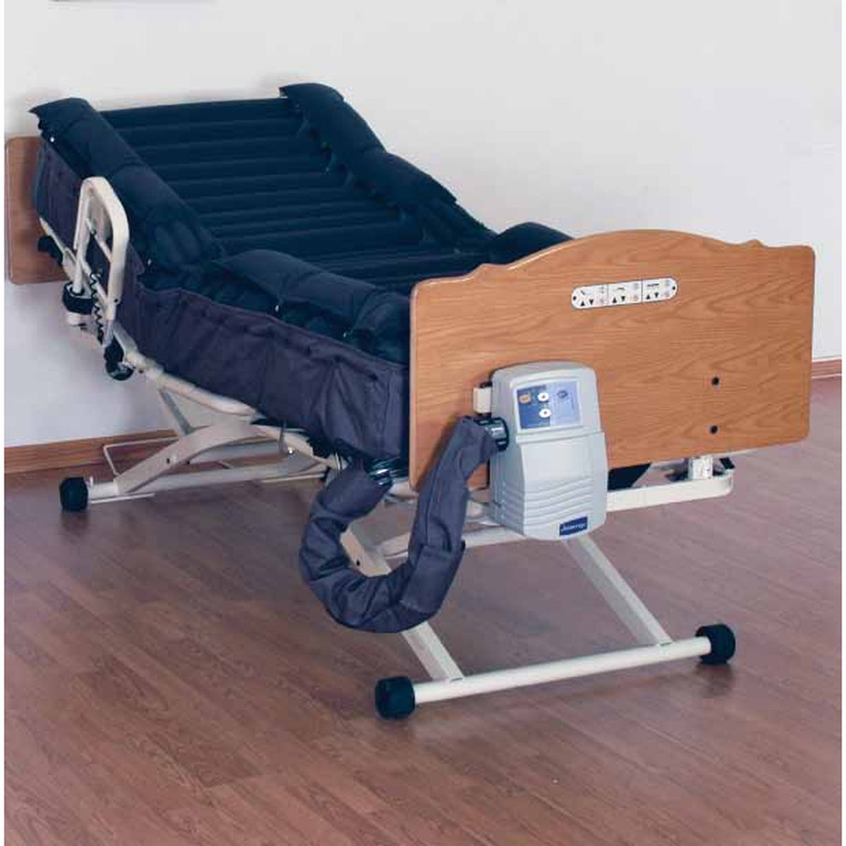 A Joerns DermaFloat LAL mattress on a bed. The control unit at the foot of the bed is a separate part