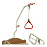 The Joerns trapeze bar and its red hand grip, mounted at the head of a bed