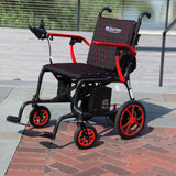The Journey Air Elite in Red parked outdoors, front three-quarter view showing the red frame accents