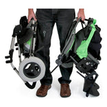 A caregiver carrying the folded Kid Kart Xpress seat and base