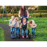 A girl in the MyWay+ with her family on a park path; the open frame leaves the front clear