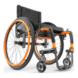 Motion Composites APEX C with Sunkissed Orange color accents and matching Air Grip handrims, front three quarter view