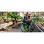 A woman using the Motion Composites Helio A7 in a garden center
