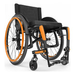 Motion Composites Veloce in High Gloss Carbon Fiber with Sunkissed Orange highlights and matching Air Grip handrims, front three quarter view