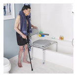 Nuprodx MC5300 one-piece sliding commode bench in a bathroom