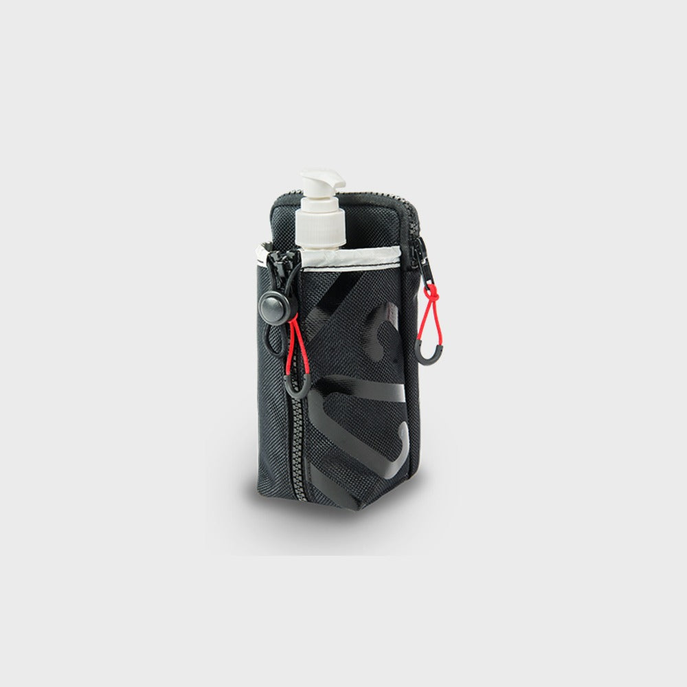 Newton multi-purpose pouch holding a sanitizer bottle