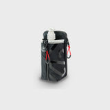 Newton multi-purpose pouch holding a sanitizer bottle
