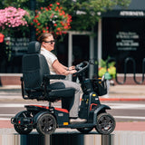 Rider on a Pride PX4 mobility scooter on a city street