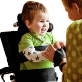 A boy standing in a Caribou at a plastic tray in a living room, playing with a girl
