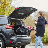 A woman lifting a Crocodile AT into the back of a car