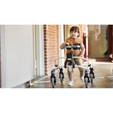 A child walking in a Mustang along a hallway