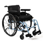 TiLite X aluminum folding wheelchair with a light blue frame, black Spinergy rear wheels and T-style armrests, front three-quarter left view